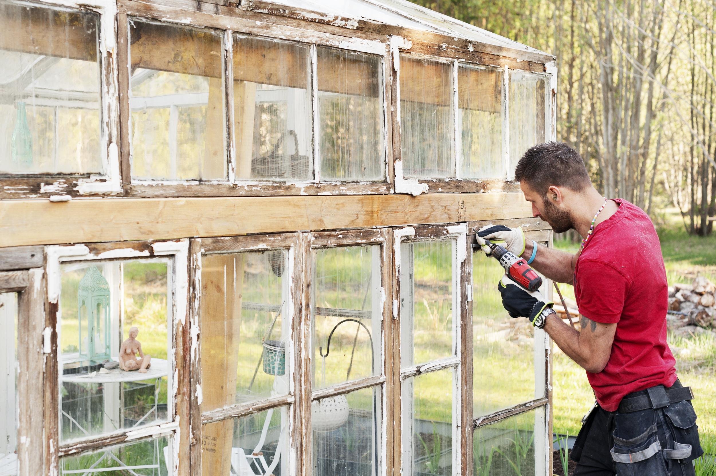 Hantverkare borrar på glashus